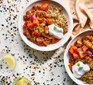 Two plates of harissa vegetables with quinoa