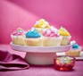 Iced fairy cakes on a cake stand
