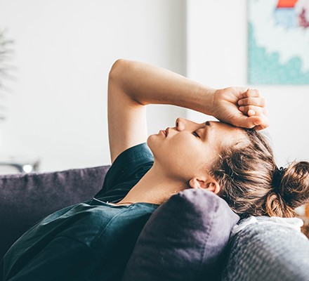 Stress relief: How diet and lifestyle can help Stressed woman on the sofa